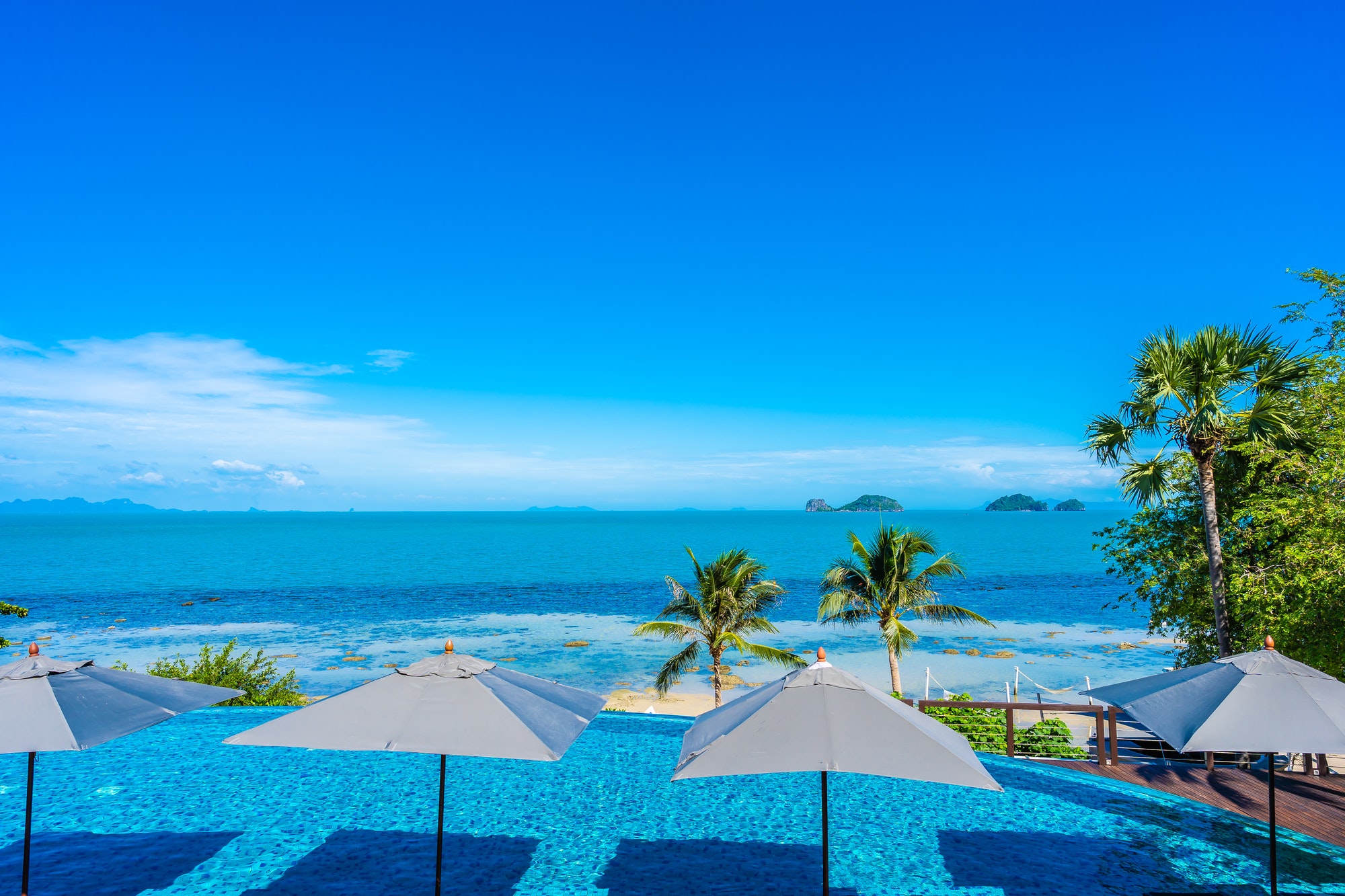 beautiful-luxury-outdoor-swimming-pool-in-hotel-resort-with-sea.jpg