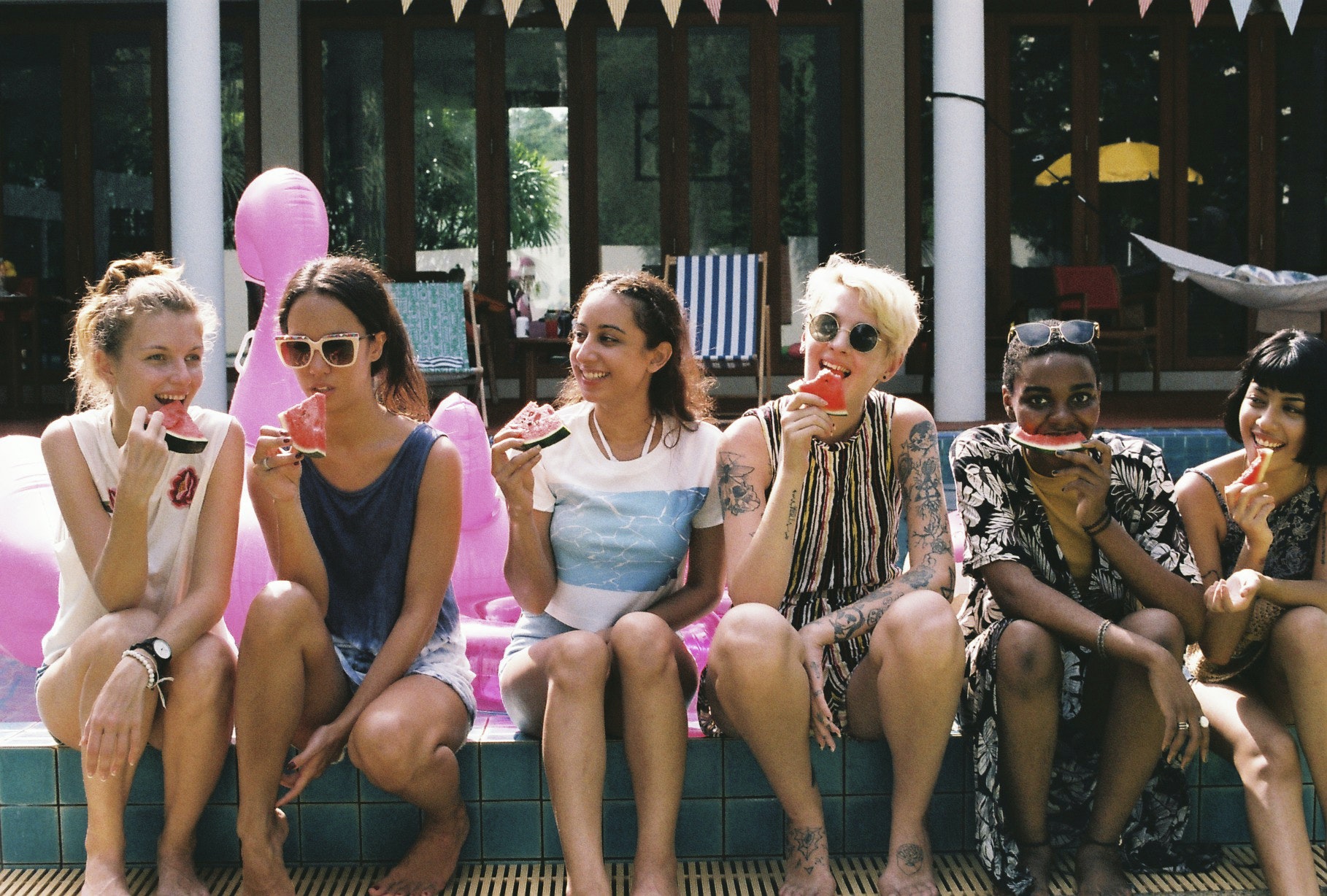 group-of-girls-friends-eating-watermelon-at-the-pool.jpg