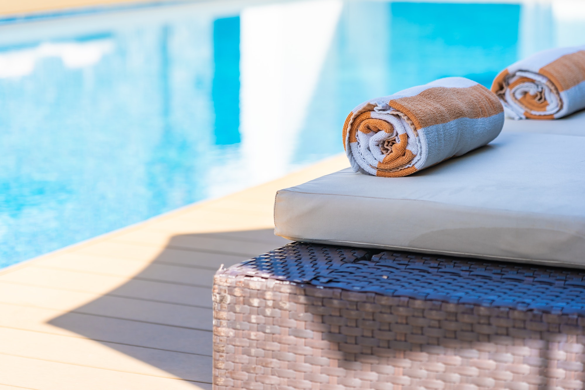 towel-on-bed-around-swimming-pool-in-hotel-resort.jpg